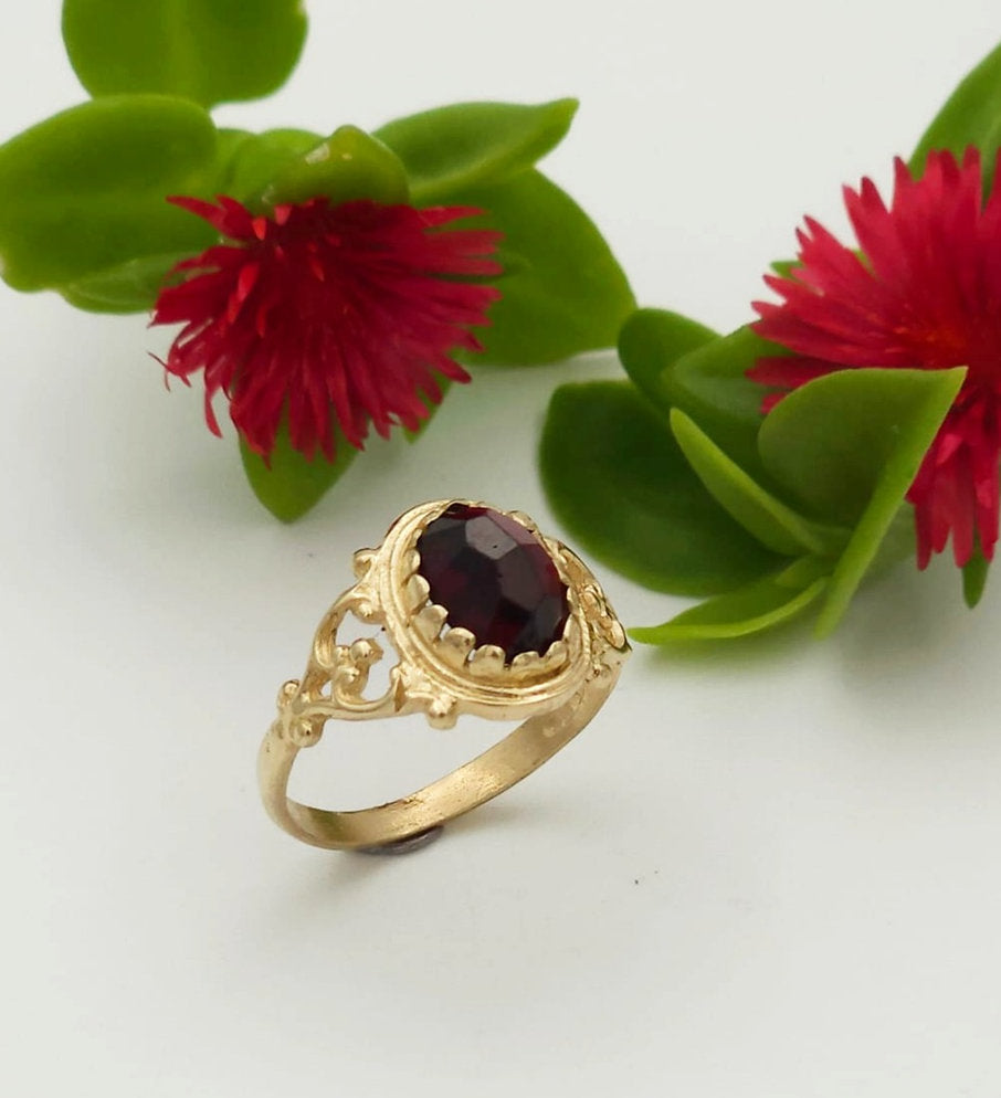 14K Gold Ring Set with an Oval Garnet Stone