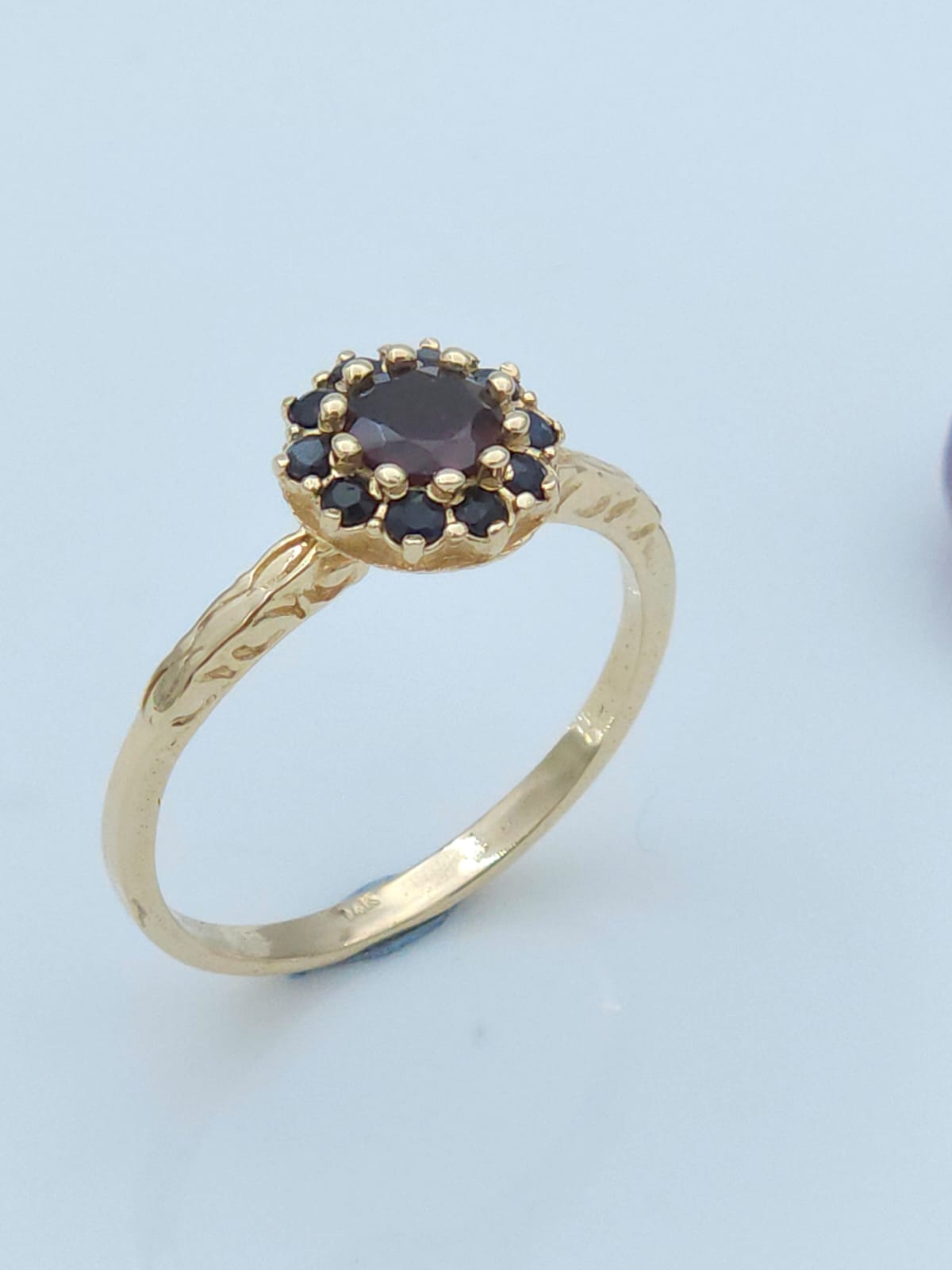 Antique style 14-karat gold ring set with garnet and sapphire stones